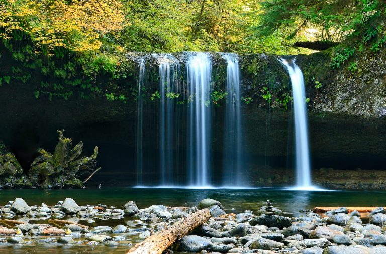 long-exposure photo of lake with waterfall at daytime