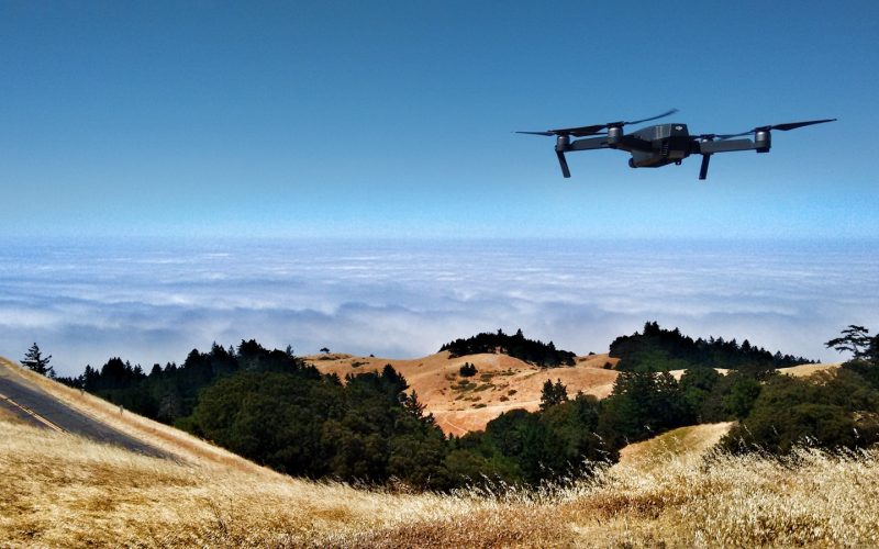 black drone on air over cloudy sky at daytime